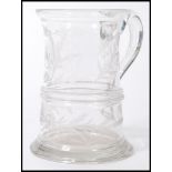 A 19th century Victorian glass handled tankard having etched floral decoration, monogrammed M. M. D.