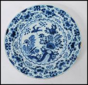 A 19th Century Delft display / serving plate of round form, having hand painted blue and white