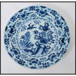 A 19th Century Delft display / serving plate of round form, having hand painted blue and white