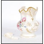 An early 19th century hand painted Staffordshire jug hand painted with floral sprays. Gilt