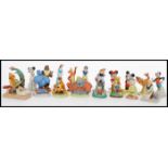 A selection of ceramic Disney character figurines to include Cinderella, Belle, Eyore, Simba, Dumbo,