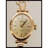 A ladies vintage 9ct gold cocktail watch by H. Samuel having an oval facet with baton markings to