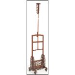 A vintage 20th century Chinese hardwood adjustable floor standing candlestick / lamp base having