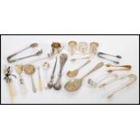 A collection of silver hallmarked and silver plated flatware to include three hallmarked napkin