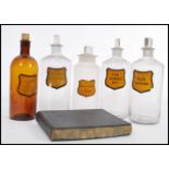 A selection of 19th Century Victorian apothecary / poison bottles having shaped yellow labels and
