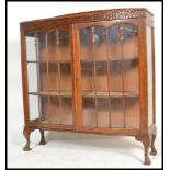 A 1920's oak glass fronted Queen Anne China display cabinet bookcase. Raised on Queen Anne