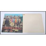 Two vintage early pressing Beatles Records comprising of The Beatles Sgt. Pepper's Lonely Hearts