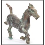 A 19th century Chinese bronze figurine of a Tang Dynasty style War Horse. 17cm high.