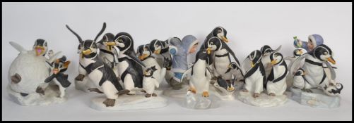 A large collection of Franklin Mint Christmas related penguin ceramic figurines to include ' We Four