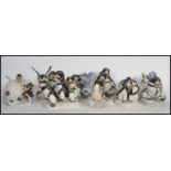 A large collection of Franklin Mint Christmas related penguin ceramic figurines to include ' We Four