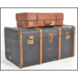 A vintage 20th Century canvas and cane bound steamer trunk, hinged top with latches to the front