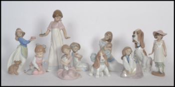 A collection of NAO ceramic figurines to include a mother and child figure, a girl holding a candle,