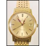 A vintage 1970's Omega Automatic Geneve watch having a gilt dial with baton numerals and date