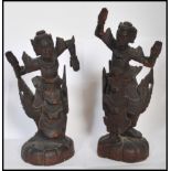 A pair of early 20th century Chinese / Asiatic wooden hand carved figurines of Buddhas / deities