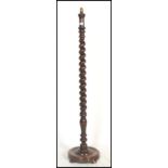 A 19th century Victorian mahogany barley twist standard lamp. Raised on a terraced base with tall