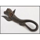 A vintage 19th Century cast metal Bully tin opener, the body modelled as a bull, the blade