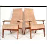 A pair of mid century teak wood high back armchairs of Danish influence having champagne velour