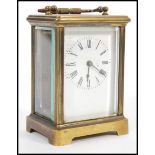A circa 1900 French lacquered brass carriage clock, the enamel dial with Roman numerals chapter