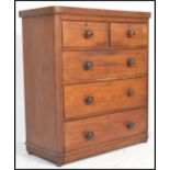 A Victorian mahogany chest of drawers having bun feet with 2 short over 3 deep drawers having knob