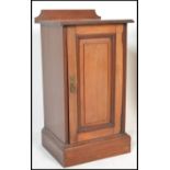 An Edwardian mahogany pot cupboard being raised on plinth base with locker door and gallery top
