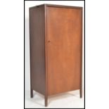 A mid century teak wood upright sentry box bachelors wardrobe with squared legs having full length