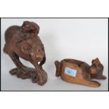 Two early 20th century carved Chinese wooden figurines to include an ox on plinth base with man