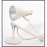 A vintage retro mid 20th century Herbert Terry industrial anglepoise lamp raised on circular base