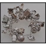 A silver hallmarked charm bracelet together with twenty - five assorted charms to include a boot,