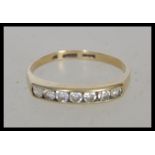 A 9ct gold ring stamped 375 having channel inset with stones to the head. Weight 1.6g. Size P.5.