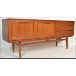 A retro 20th Century teak sideboard / credenza of Danish inspiration, having a run of three