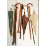 A collection of vintage walking sticks canes from the 20th Century together with a stunning silk