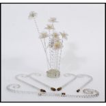 A selection of decorative glass flowers having twisted stems and flowers to the head within a