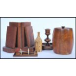 A collection of wooden treen items to include a lead lined barrel shaped caddy, a turned wooden