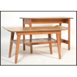 A 1970's teak wood rectangular coffee table with squared legs united by stretchers together with
