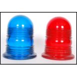 A pair of vintage coloured glass police siren light covers in blue and red. 12cm high 10cm diameter.