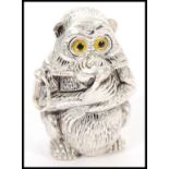 A silver plated vesta in the form of a monkey having yellow and black glass eyes and a hinged head