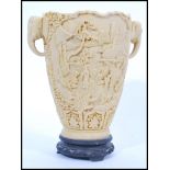 A 20th Century Chinese composite carved vase depicting a detailed landscape scenes with ladies in