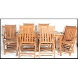A large good quality garden patio teak dining table and chairs suite from the Chilworth