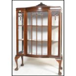 An early 20th century 1920's mahogany china display cabinet / bookcase having claw and ball feet