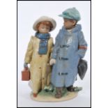 A Lladro model of two children walking hand in hand in winter clothes, inscribed no.2242 to the