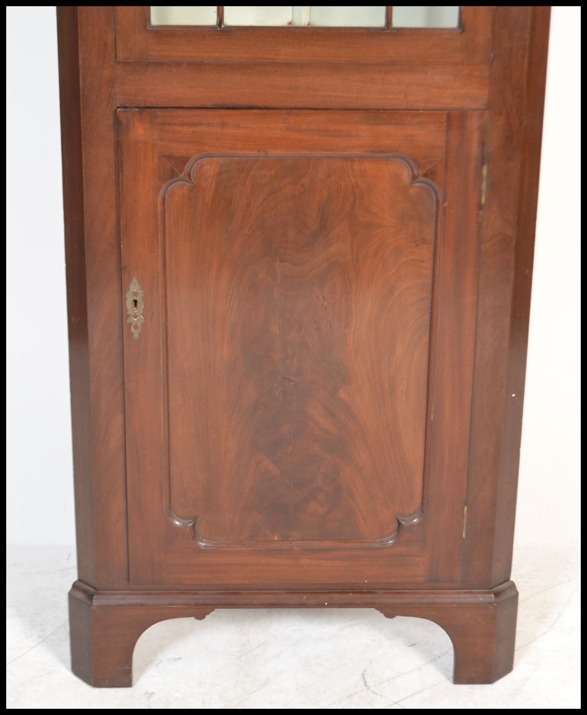 A Georgian 19th century mahogany corner cupboard of thin proportions having astragal glazed - Image 2 of 5