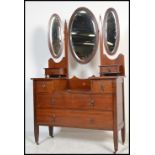 An early 20th century Edwardian mahogany inlaid dressing table desk raised on tapering block legs