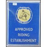 A retro 20th Century glass advertising sign, the sign on blue ground advertising APPROVED RIDING