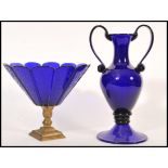 Two blue glass wares to include a large Bristol blue acid signed twin handled vase raised on