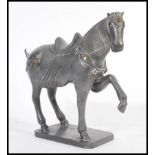 A 20th Century Chinese Tang dynasty style metal war horse figurine on a square base having its front