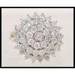 A stamped 375 9ct gold diamond cluster ring having a large round head prong set with brilliant cut