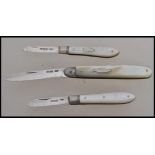 A group of three silver hallmarked and mother of pearl handled fruit pen knives. One hallmarked