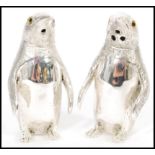 A pair of stamped 800 silver condiments / salt and pepper shakers in the form of penguins having