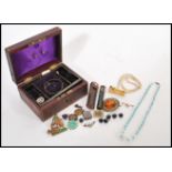 A collection of vintage costume jewellery dating from the early 20th Century housed within a 19th