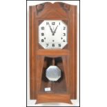 A vintage 20th century Art Deco French walnut cased wall clock, with silvered dial by Vedette having